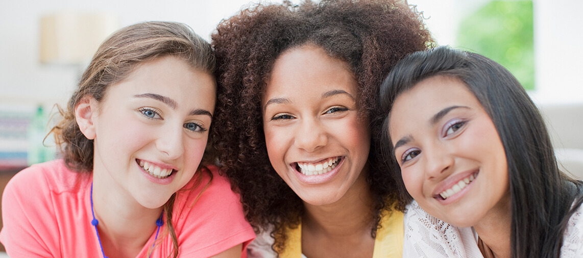 group of three smiling girls